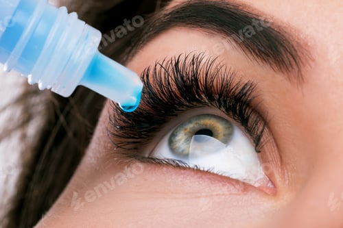 Preview: Studio shot of beautiful woman using eye drops