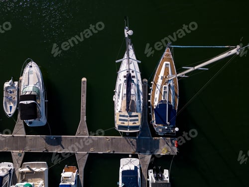 Preview: Aerial view of a yacht marina by the sea, adorned with elegant yachts, creating a picturesque