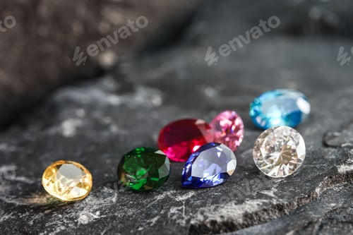Preview: Glimmering natural colorful sapphire gemstones on a rugged rock surface