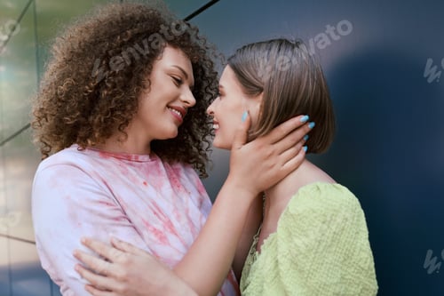 Preview: Joyful young couple sharing an intimate moment in a vibrant urban setting during sunny afternoon