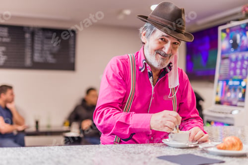 Preview: senior male take a coffee and croissant breakfast in a bar place with a mask. New normal covid-19