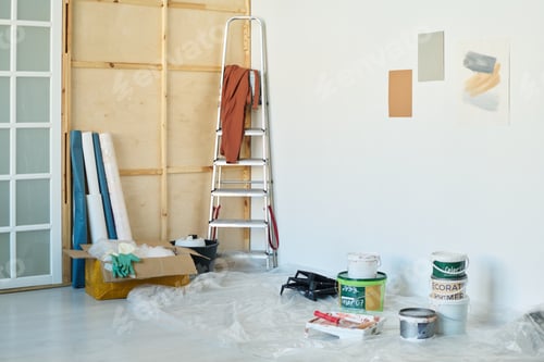 Preview: Corner of spacious living room of new apartment with buckets of paints