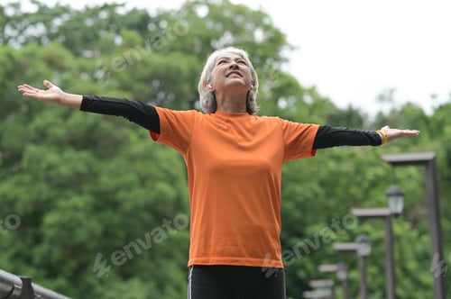 Preview: Elderly woman exercising outdoors.