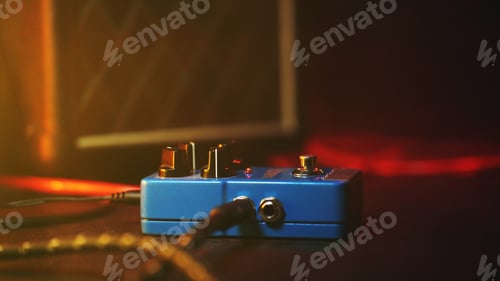 Preview: loop pedal for electric guitar. Close up of effect machine on concert scene. Macro view. Neon light.