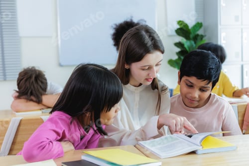Preview: Diversity of elementary students studying with teacher guiding in classroom using textbook
