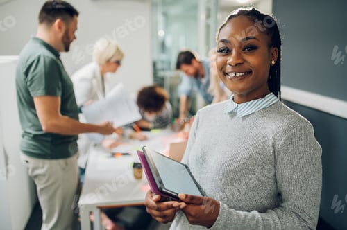 Preview: Businesswoman posing and smiling during a meeting in an office
