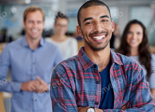 Preview: Cropped portrait of positive young man with colleagues in the background
