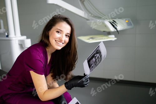 Preview: beautiful woman doctor with dental equipment in dentistry