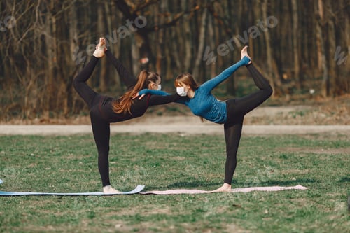 Preview: Cute girls doing yoga in a masks