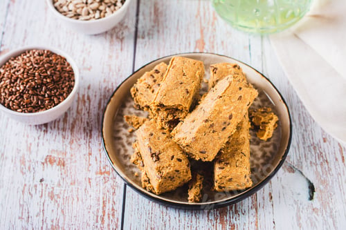 Preview: Pieces of halva with flax seeds on a plate on the table