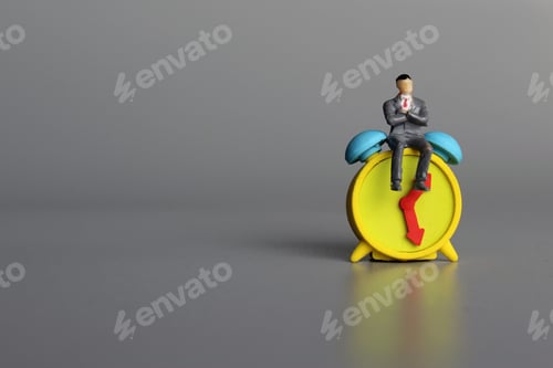 Preview: Man sit on top of alarm clock.