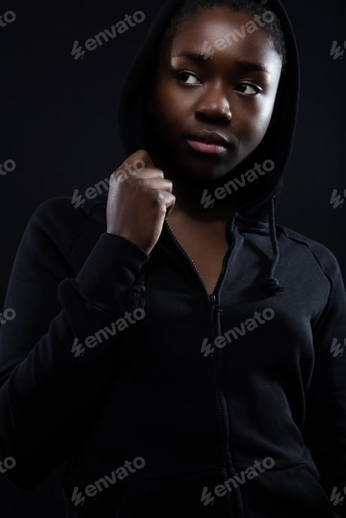 Preview: Cool and confident woman with dark skin and attitude wearing hoodie