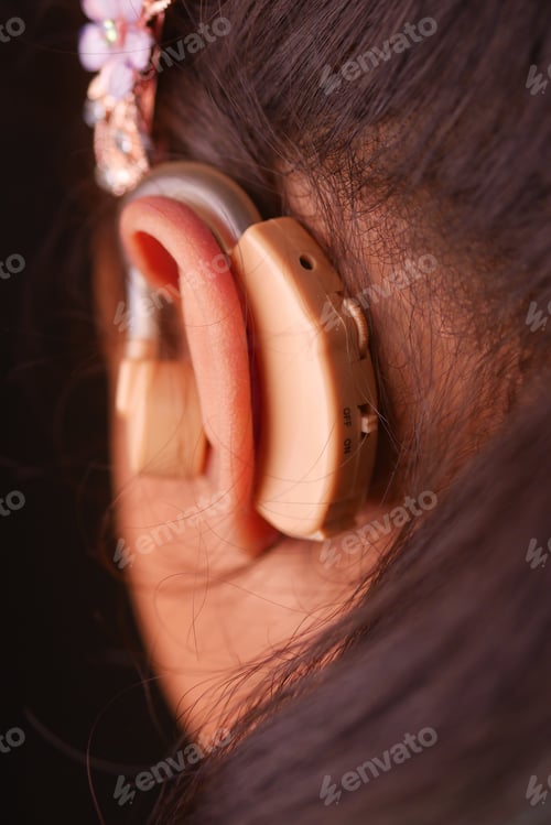 Preview: Hearing aid concept, little girl with hearing problems.