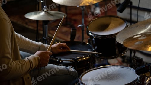 Preview: High angle shot of a person playing drums in a studio