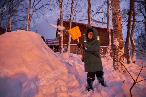 Preview: A family builds a slide in the yard in winter.
