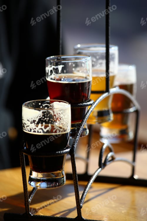 Preview: A flight of beautiful colored beer in a curved glass holder.