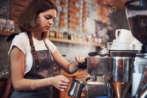 Preview: That's how fresh drink makes. Young female cafe worker indoors. Conception of business and service