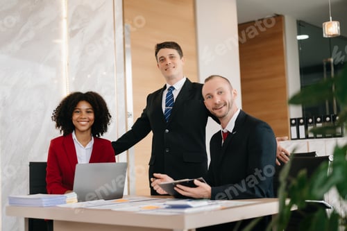Preview: Happy businesspeople while collaborating on a new project in an office. Group of diverse