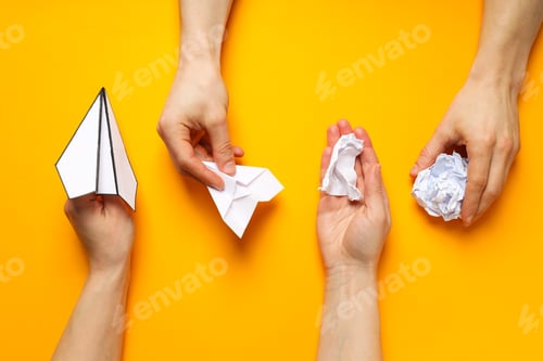 Preview: Business, startup and sponsorship concept with paper planes and hands on yellow background