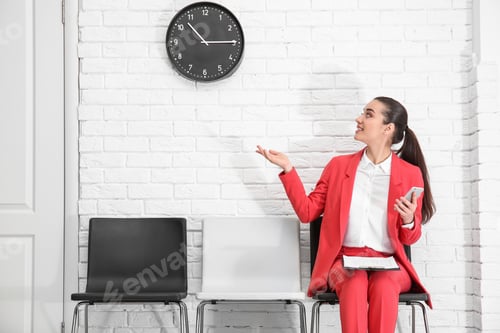 Preview: Young woman waiting for job interview, indoors