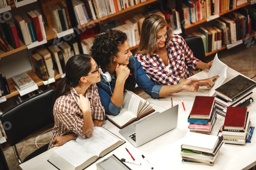 Preview: Group of female students study in the college library.