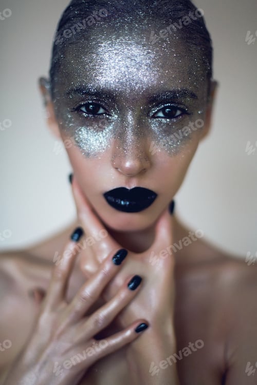 Preview: fashionable makeup portrait of woman with silver paint and black lips.