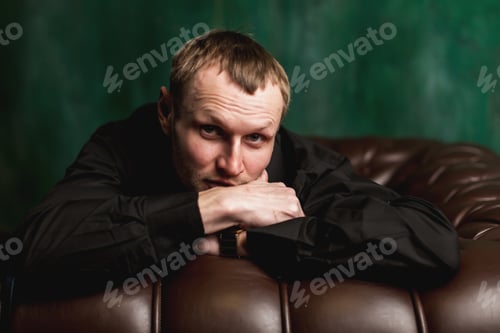 Preview: Portrait of an elegant stylish handsome man on dark background