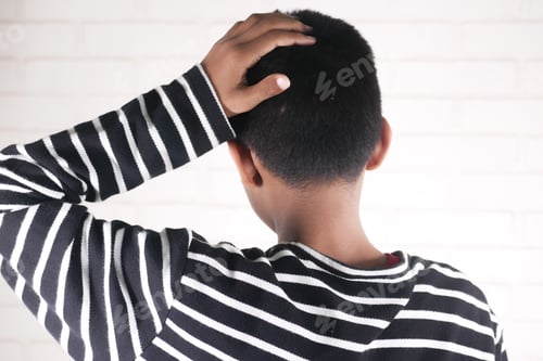 Preview: sad teenage boy covering his face sitting on sofa
