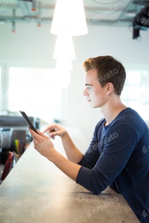 Preview: Young man using tablet
