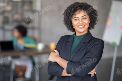 Preview: Confident businesswoman smiling in diverse corporate office environment
