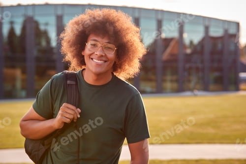 Preview: Portrait Of Male University Or College Student Standing Outdoors By Modern Campus Building