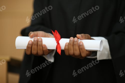 Preview: group of multiracial graduates holding diploma