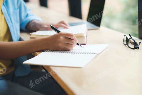 Preview: Close up of woman studying, reading book, and taking notes.