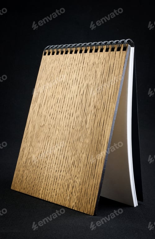 Preview: Wooden notebook on a dark background.