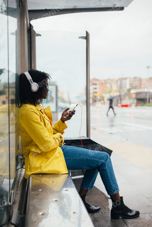 Preview: Woman Listens to Music Waiting at Bus Stop