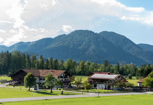 Preview: Landscape of buildings surrounded by hills covered in greenery in Ruhpolding, Germany