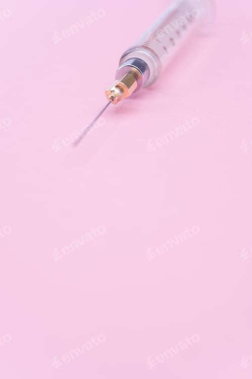 Preview: isolated sterilized glass injection syringe on a lilac paper background