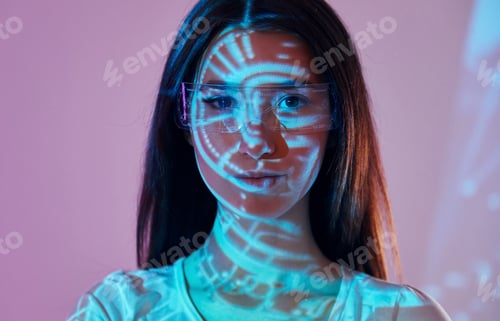 Preview: Abstract picture. Beautiful young woman is in projector neon lights in the studio