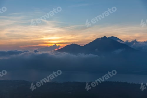 Preview: Sunrise at the top of the mount Batur in Bali, Indonesia. Clouds below the point of view.