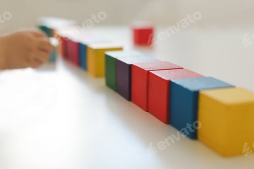 Preview: Child hands playing with montessori toys, educational toys, arranging and sorting colors and sizes.