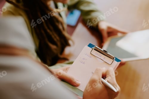 Preview: Writing Notes During Business Strategy Meeting