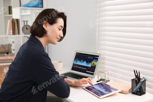 Preview: Stock exchange. Woman analysing financial market on tablet at white table indoors