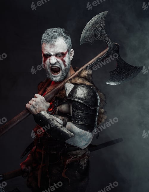 Preview: Screaming mythical warrior with painted skin and axe in studio