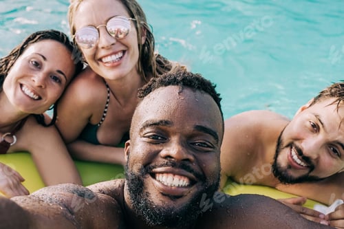 Preview: Multiracial friends at pool party doing selfie during summer vacation - Focus on African man