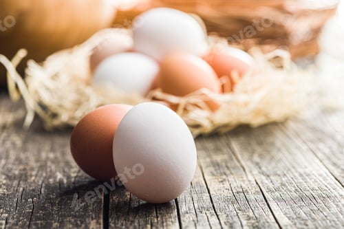 Preview: Whole chicken eggs on wooden table.