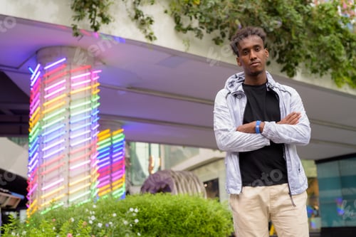 Preview: Portrait of handsome black African man with cool attitude arms crossed