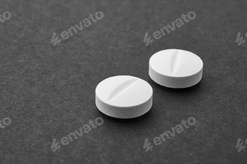 Preview: Pills over a black background. Medicament treatment. Health care photo