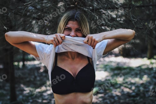 Preview: Woman in Bra Poses Playfully Outdoors