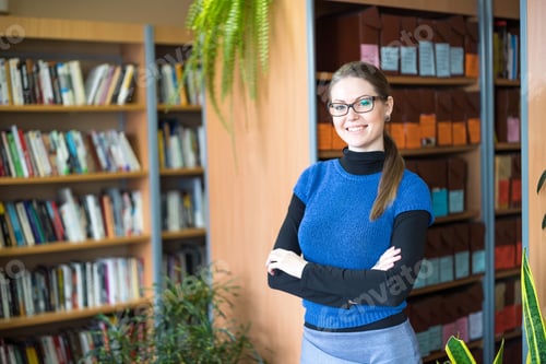 Preview: Portrait Of A Smiling Woman With Glasses In Library