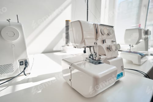 Preview: Modern sewing machine on table in atelier